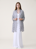 Noori Couture bronze Kashmiri wool shawl with delicate Valentino lace trim draped over a model in a white dress.