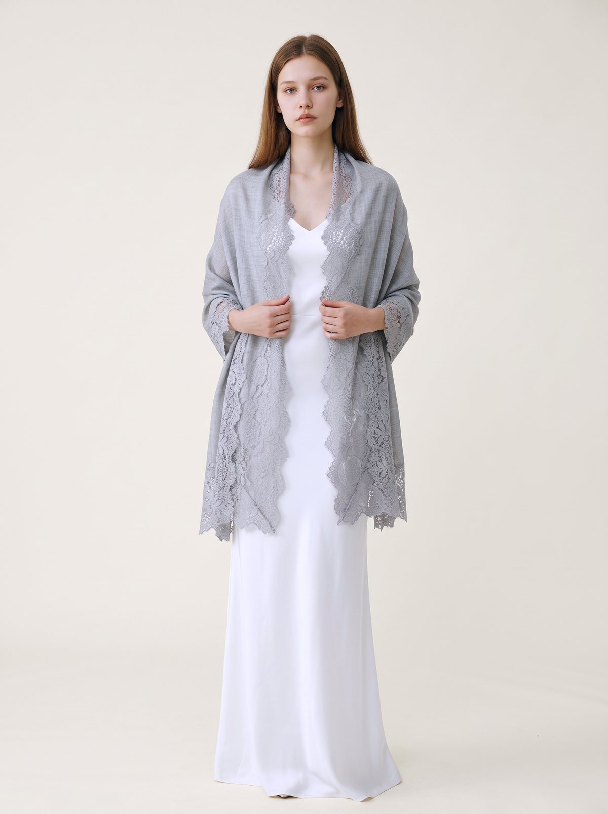 Noori Couture bronze Kashmiri wool shawl with delicate Valentino lace trim draped over a model in a white dress.