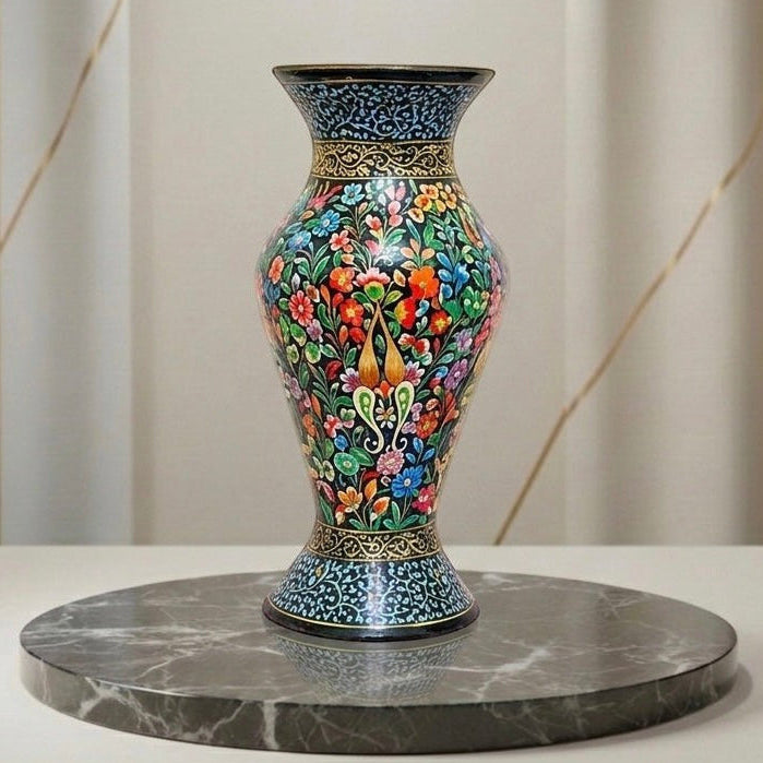 Noori Couture hand-painted paper mâché vase with intricate floral patterns in vibrant colors on a shade of blue, featuring unique accents.