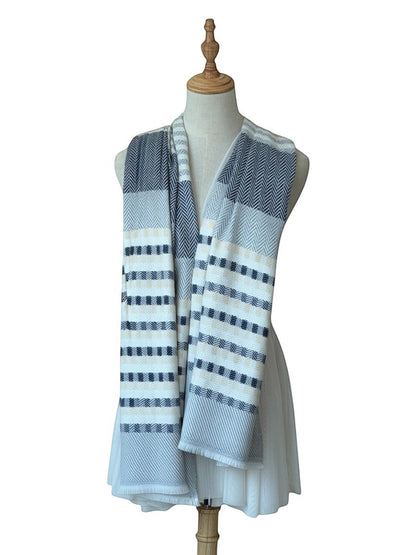 Noori Couture cashmere scarf with grey, white, and pale yellow stripes and herringbone pattern. Displayed on a mannequin.