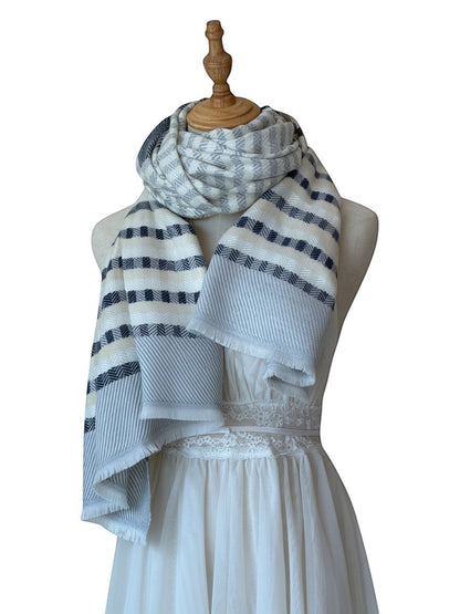 Noori Couture cashmere scarf with grey, white, and pale yellow stripes and herringbone pattern. Fringed edges.