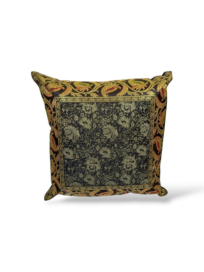 Noori Couture black and gold brocade cushion cover with floral and paisley motifs, rich texture, and ornate detailing.