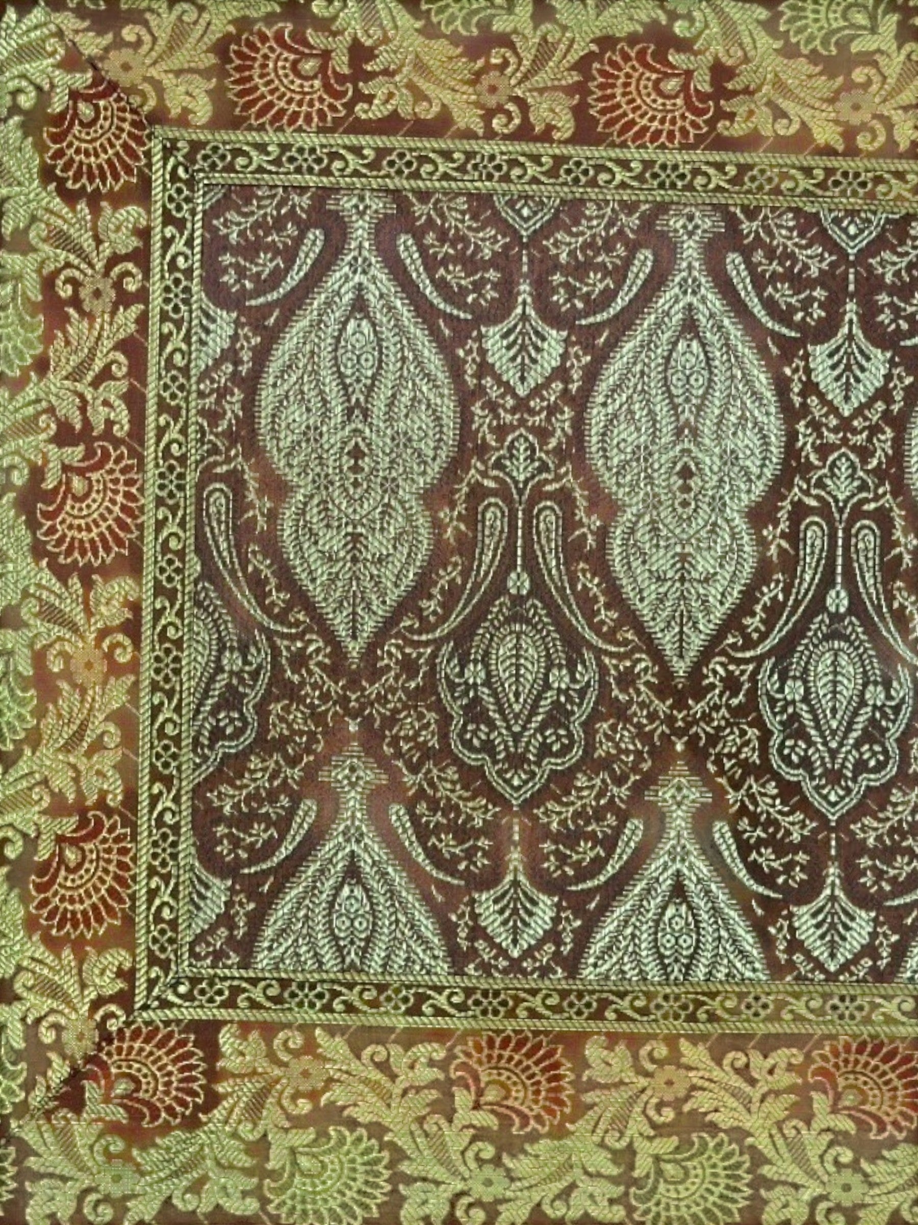 Noori Couture Banarasi brocade cushion cover with intricate zari detailing in brown, green, and red.