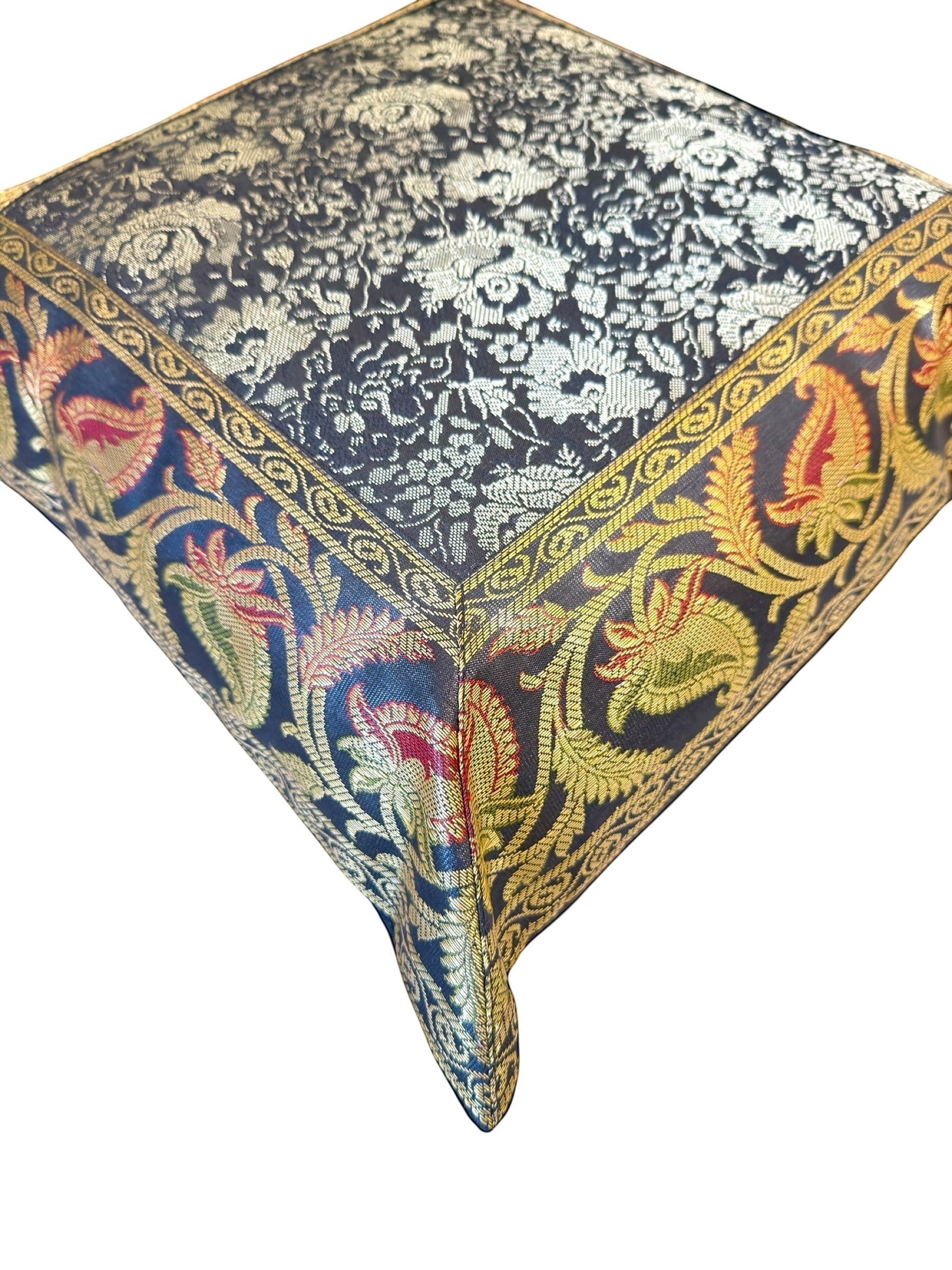 Noori Couture Banarasi brocade cushion cover with intricate gold zari floral motifs and paisley border in navy, red, and green.