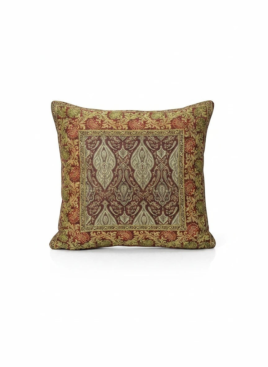 Noori Couture Banarasi brocade cushion cover in deep red with gold and green intricate zari detailing and paisley motifs.