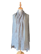 Noori Couture bronze Kashmiri wool shawl featuring delicate Valentino lace trim on a mannequin display
