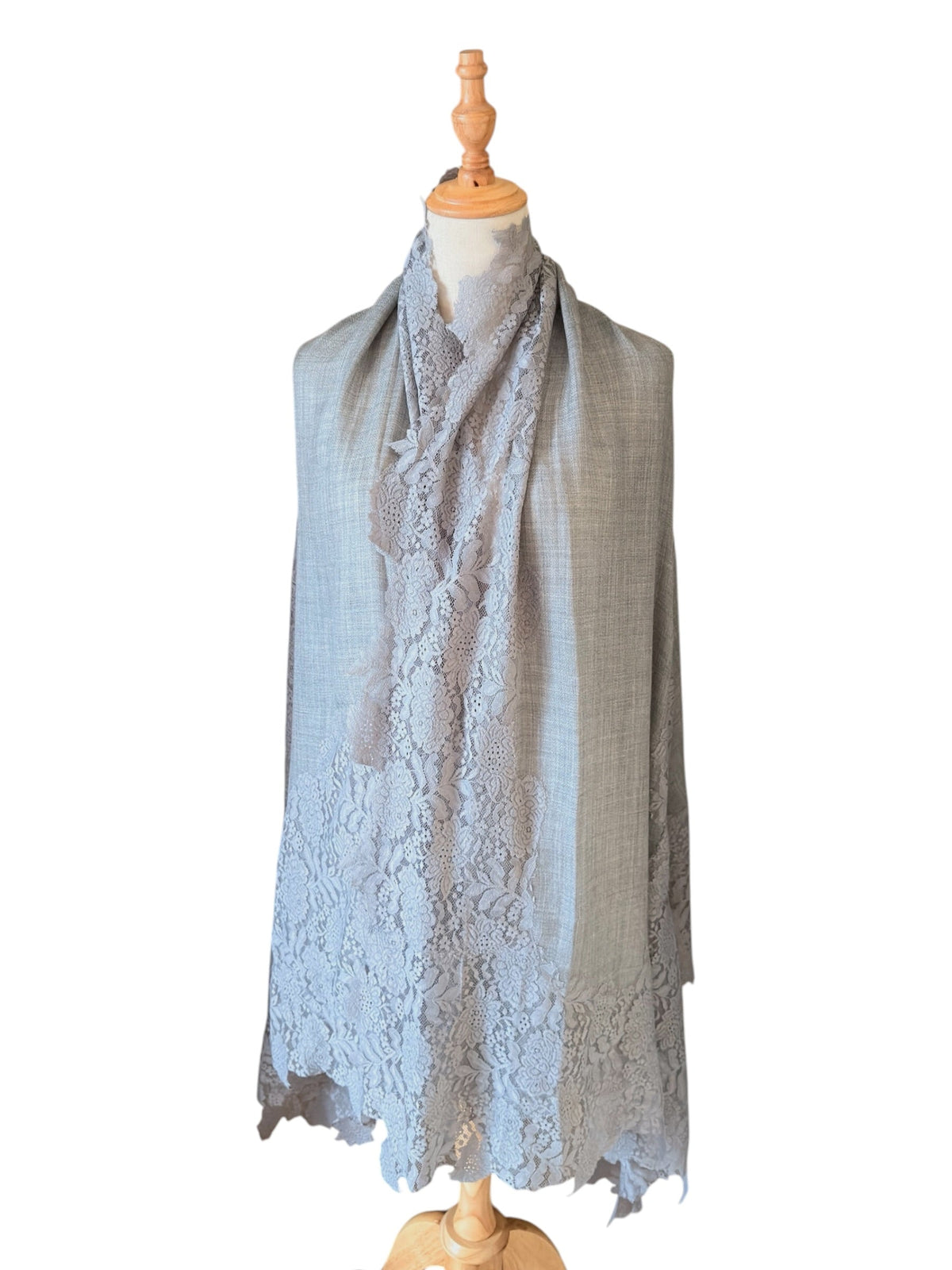 Noori Couture bronze Kashmiri wool shawl featuring delicate Valentino lace trim on a mannequin display