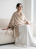 A model wearing a Noori Couture handwoven coffee-coloured pure mulberry silk shawl with intricate paisley patterns.