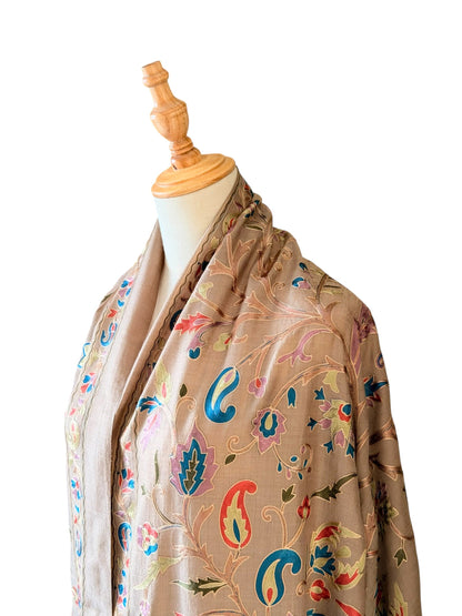 Noori Couture cream wool shawl featuring intricate multi-colored silk floral and paisley embroidery on a mannequin.