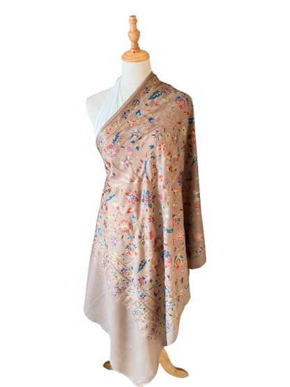 Noori Couture cream wool shawl featuring intricate multi-colored silk floral and paisley embroidery on a mannequin.