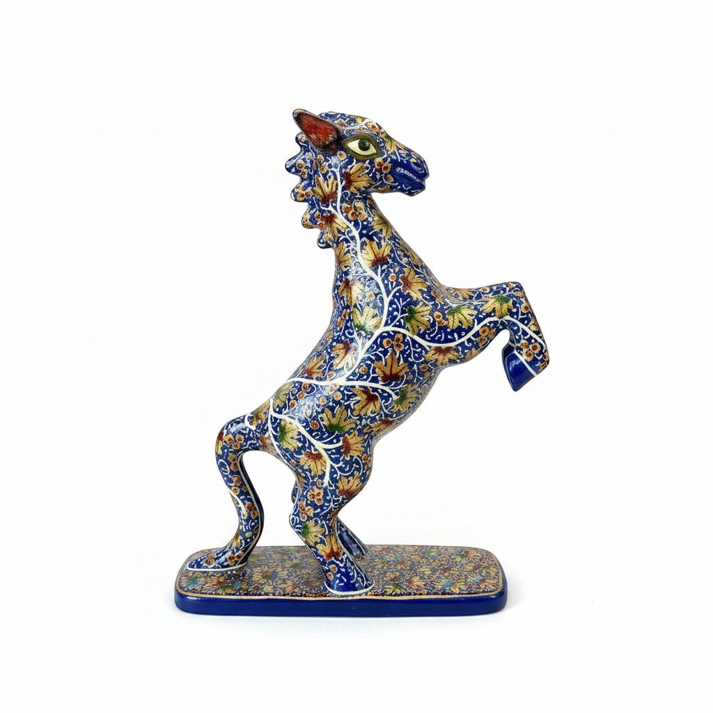 Noori Couture hand-painted horse sculpture rearing on hind legs, detailed blue body with gold floral patterns.