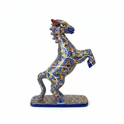 Noori Couture hand-painted horse sculpture rearing on hind legs, detailed blue body with gold floral patterns.