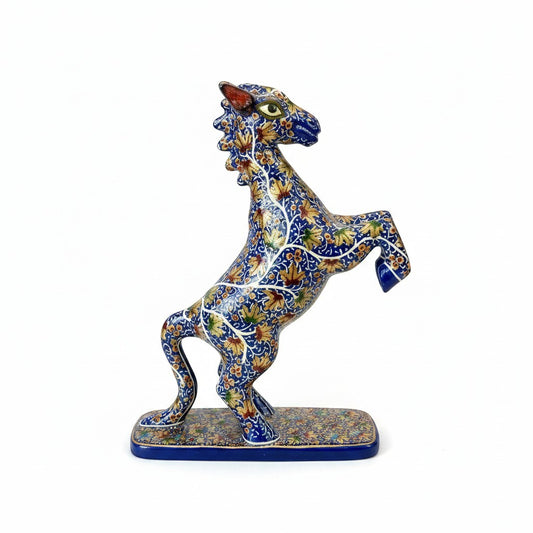 Noori Couture hand-painted horse sculpture rearing on hind legs, detailed blue body with gold floral patterns.