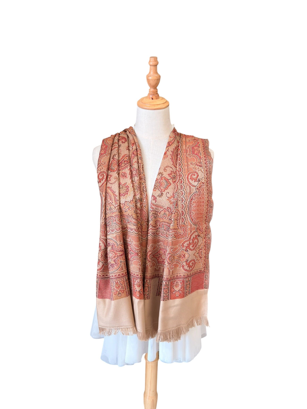 Noori Couture desert brown pashmina shawl featuring an intricate paisley pattern and delicate fringe trim on a mannequin.