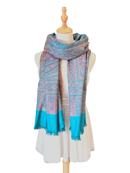 Noori Couture seaweed green pashmina shawl with intricate paisley patterns and delicate fringe on a mannequin