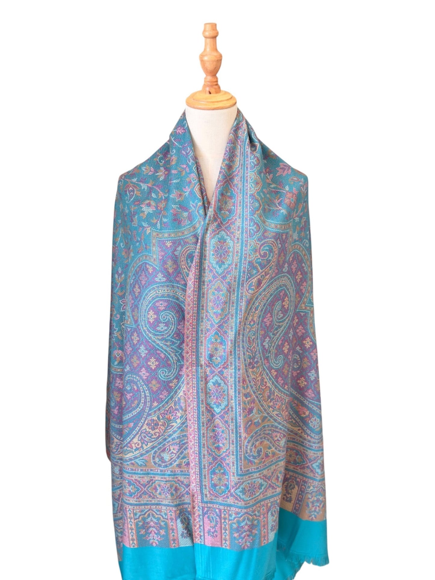 Noori Couture seaweed green pashmina shawl featuring intricate paisley patterns in teal and purple with fringe ends.