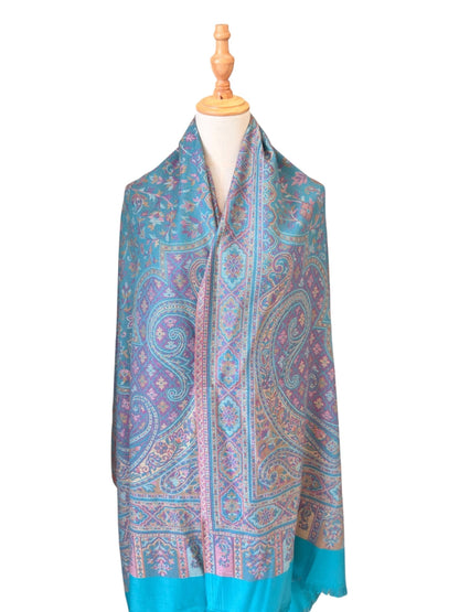 Noori Couture seaweed green pashmina shawl featuring intricate paisley patterns in teal and purple with fringe ends.