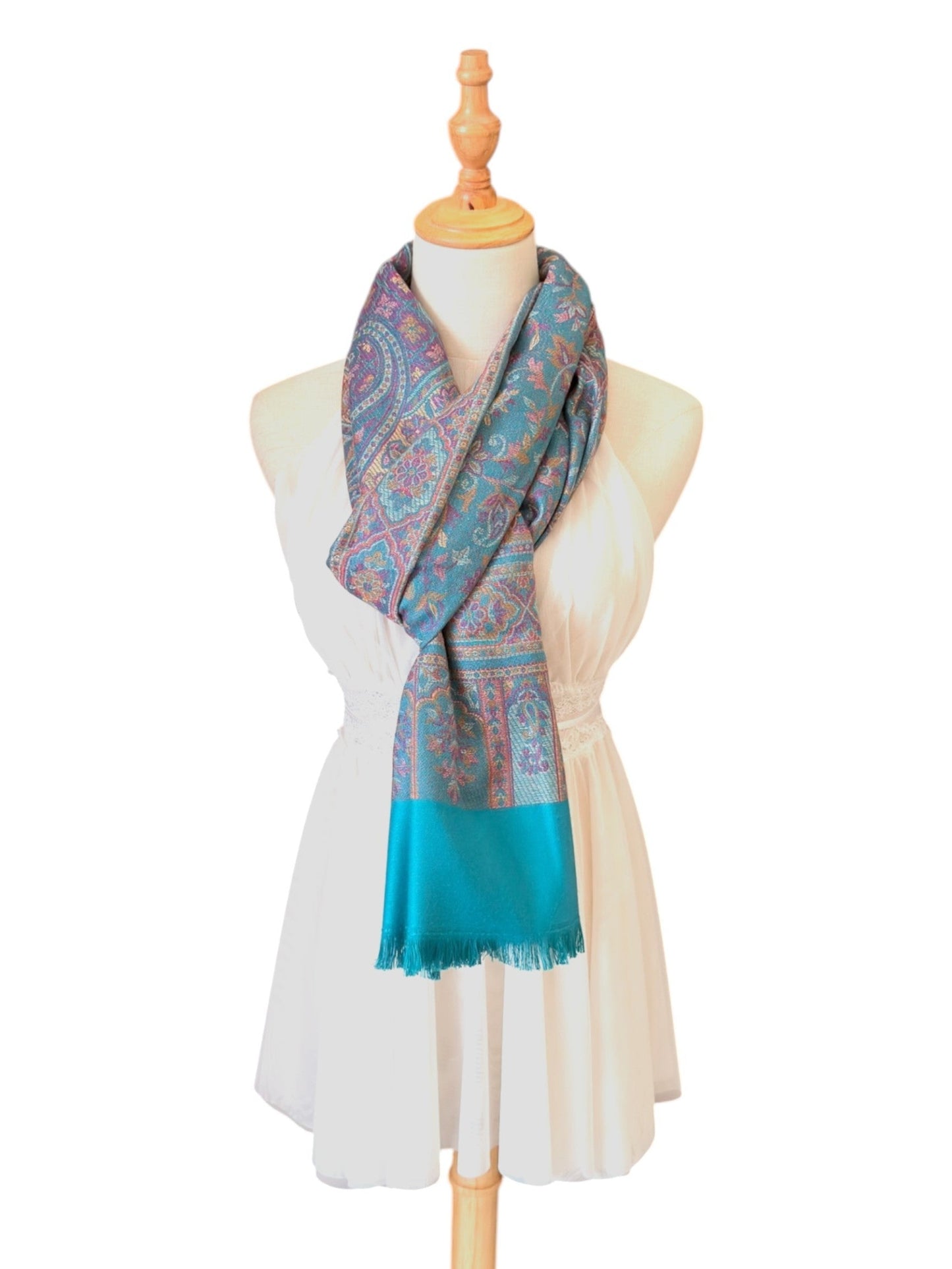 Noori Couture seaweed green pashmina shawl with intricate paisley patterns and delicate fringe on a mannequin