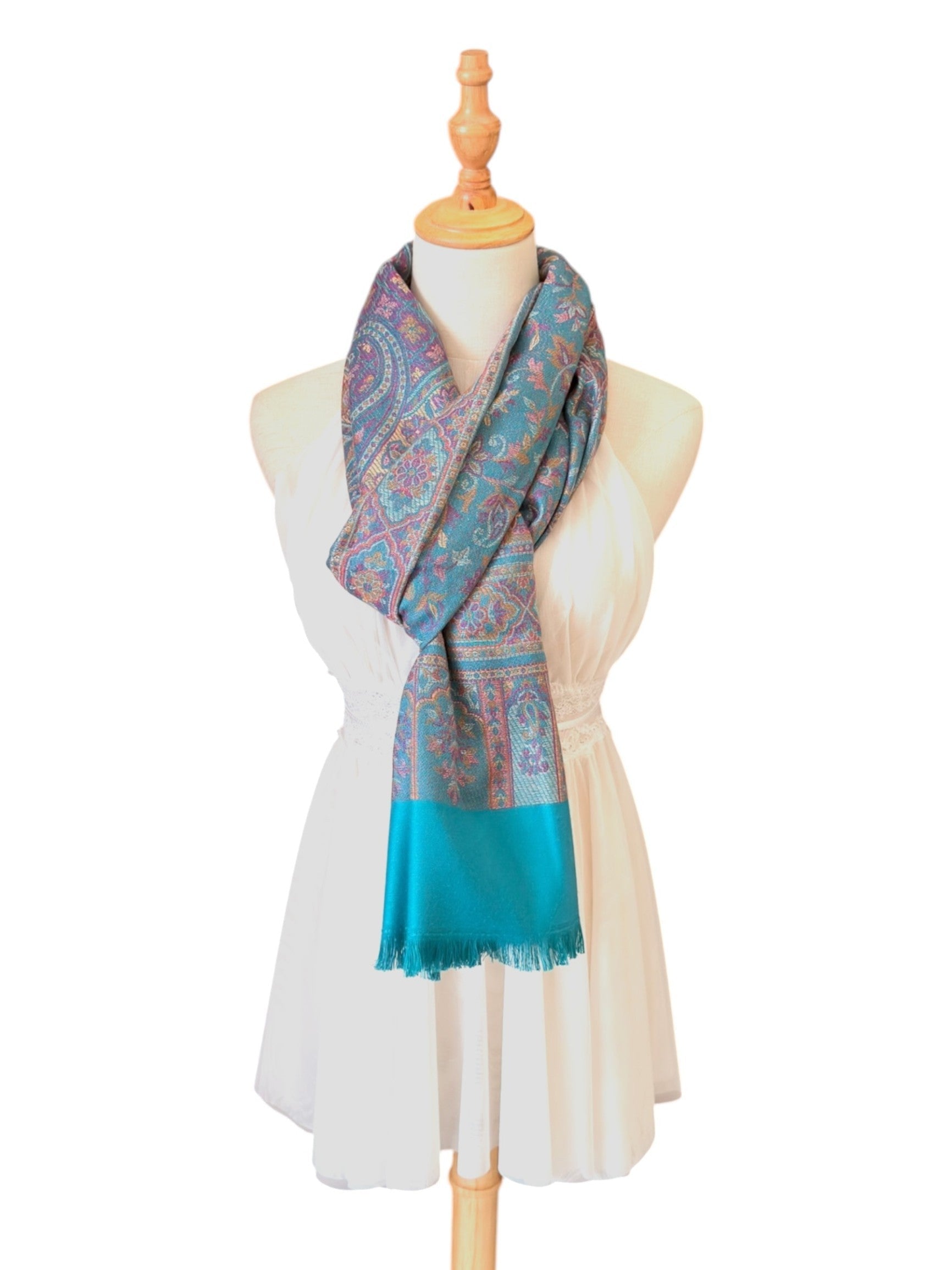 Noori Couture seaweed green pashmina shawl with intricate paisley patterns and delicate fringe on a mannequin