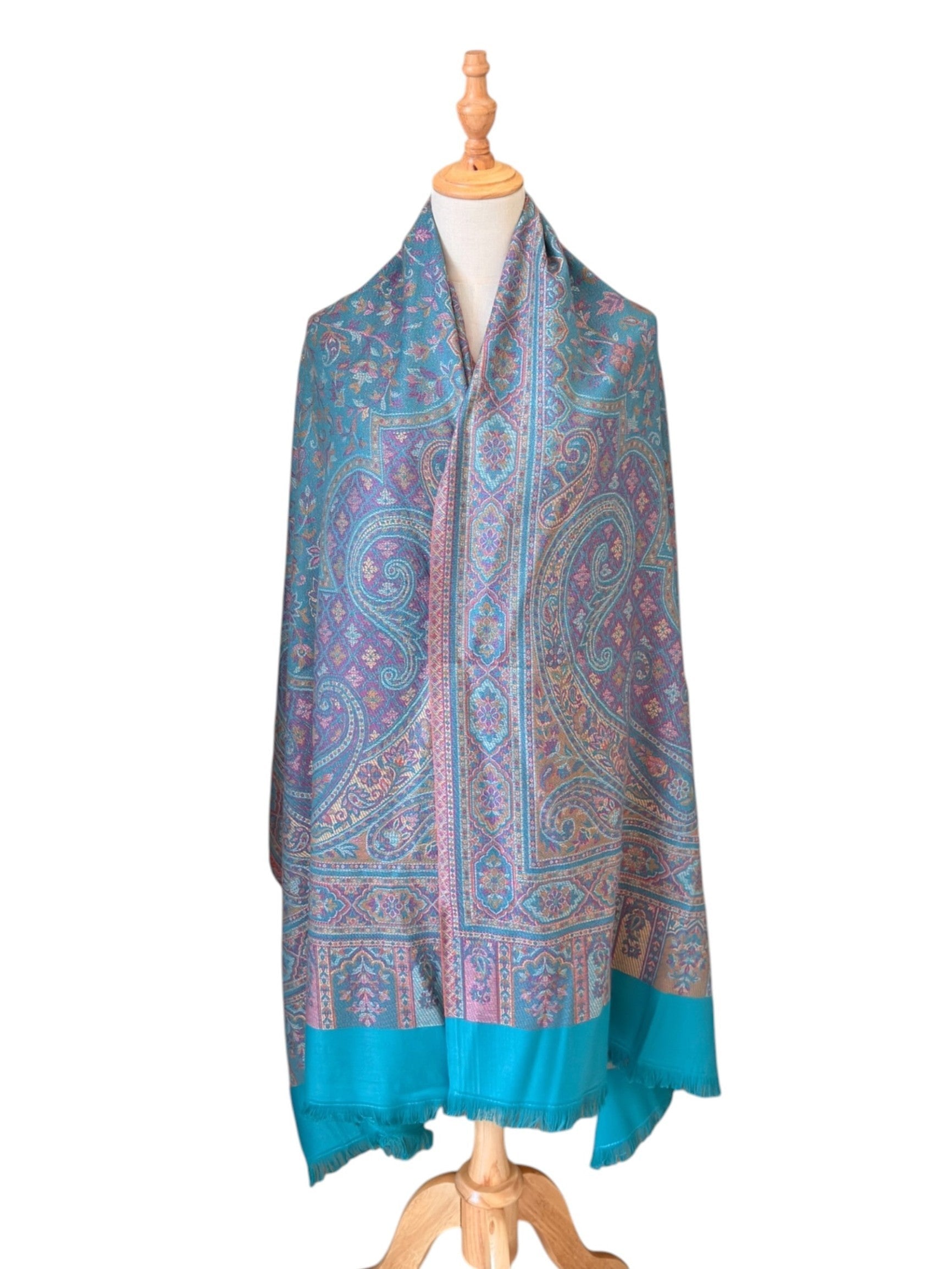 Noori Couture seaweed green pashmina shawl with intricate paisley patterns, teal and purple motifs, and fringe trim.