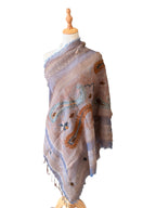 Noori Couture grey boiled merino wool shawl with intricate hand-embroidered paisley patterns and frayed edges.