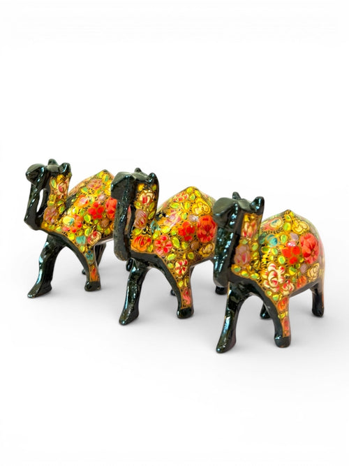 Noori Couture hand-painted black camel figurines with vibrant floral patterns and glossy finish.