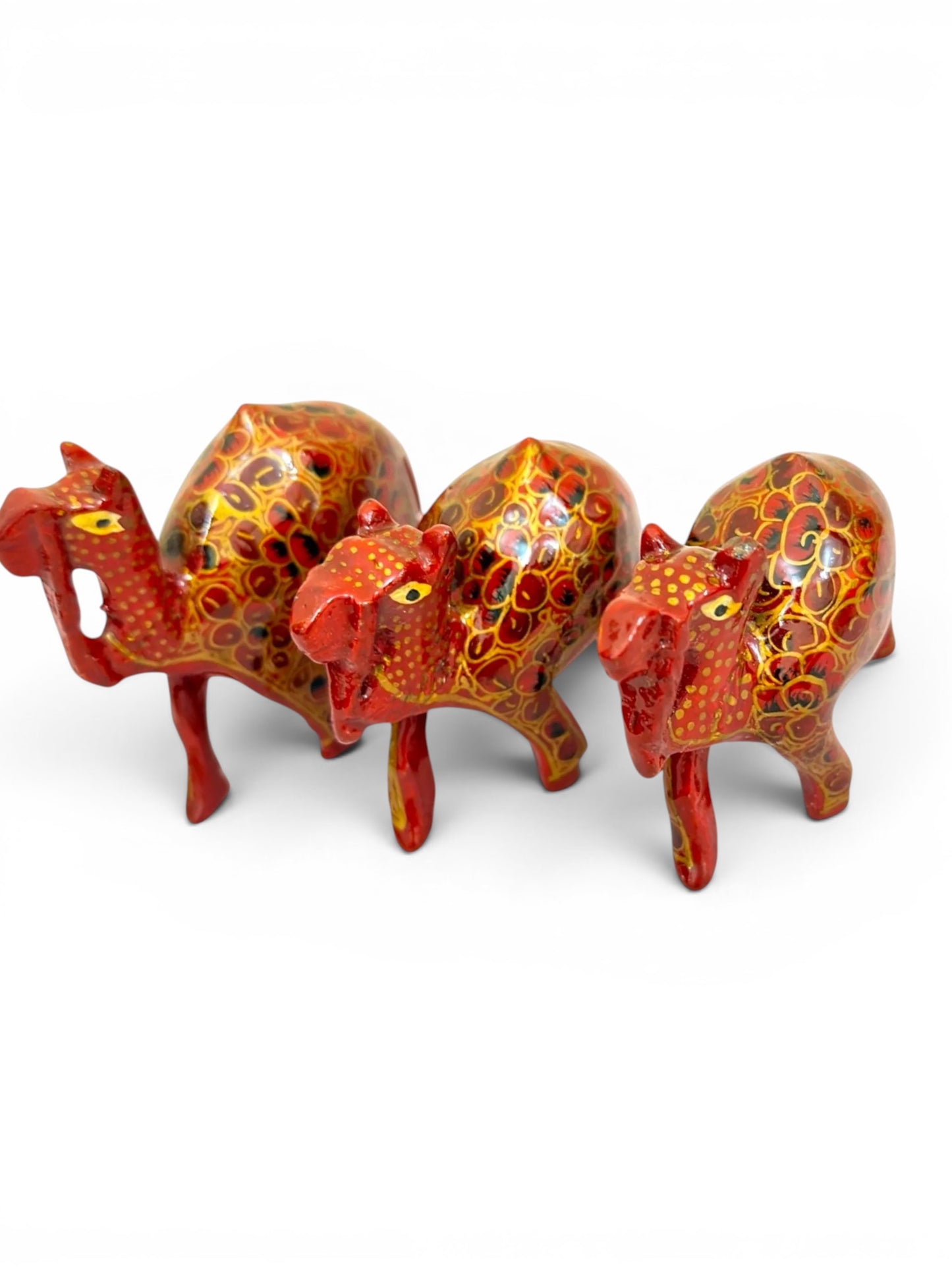Noori Couture set of 3 hand-painted red and gold papier-mâché camel figurines with floral detailing.