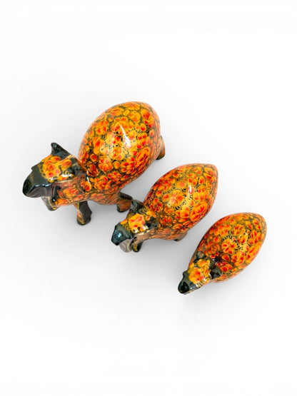 Noori Couture set of 3 hand-painted papier-mâché camel figurines with intricate golden detailing on a rich brown finish.