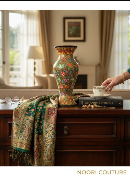Noori Couture hand-painted green vase with colorful floral and golden patterns. Curved silhouette, decorative accent.