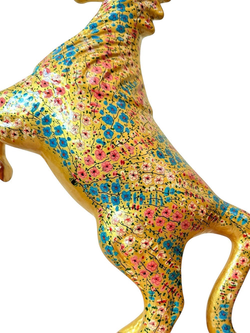Noori Couture hand-painted paper mache horse figurine with intricate pink and blue floral design on a gold finish.