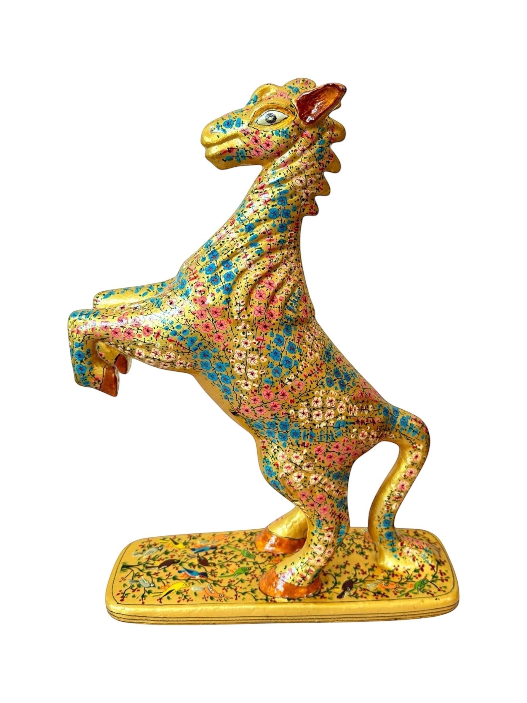 Noori Couture hand-painted paper mache horse figurine with floral design in pink and blue on gold finish, rearing pose on decorated base.