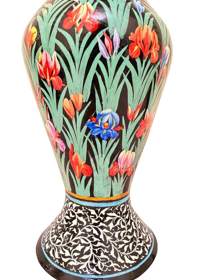 Noori Couture hand-painted paper mâché vase with green grass base, vibrant floral details, and black and white ornamental border. Limited edition art piece.