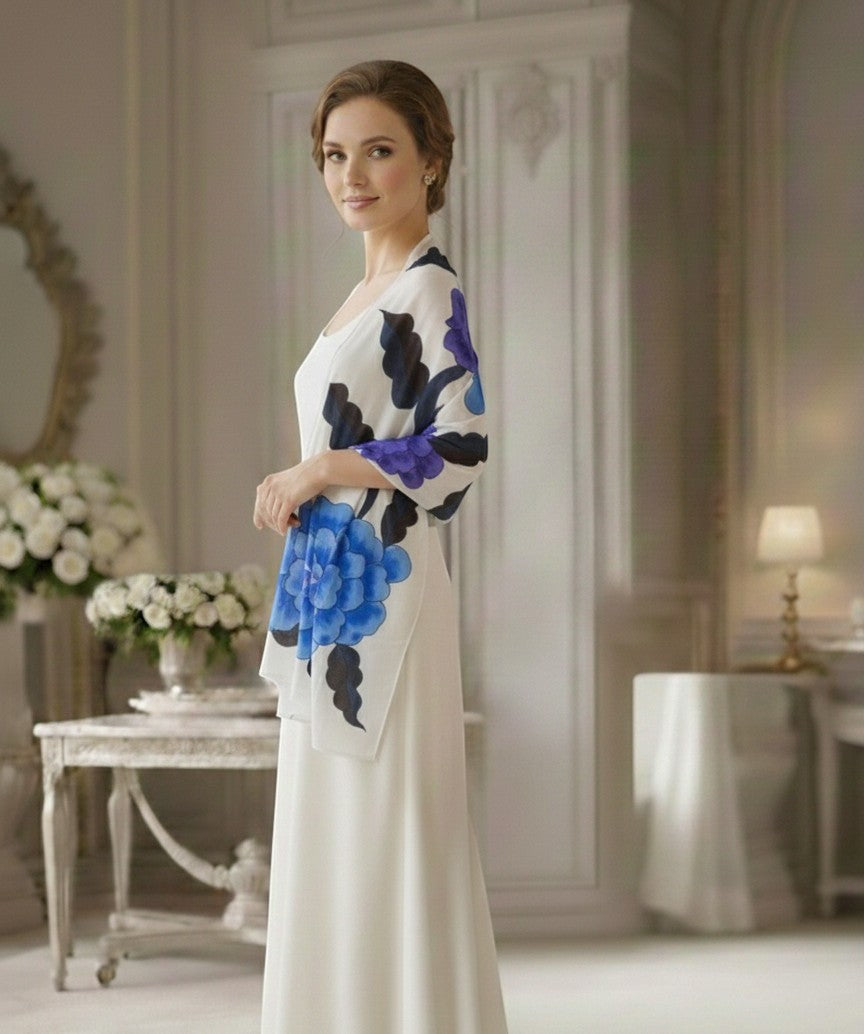 Noori Couture limited edition hand-painted shawl with blue and purple floral design on white fabric.