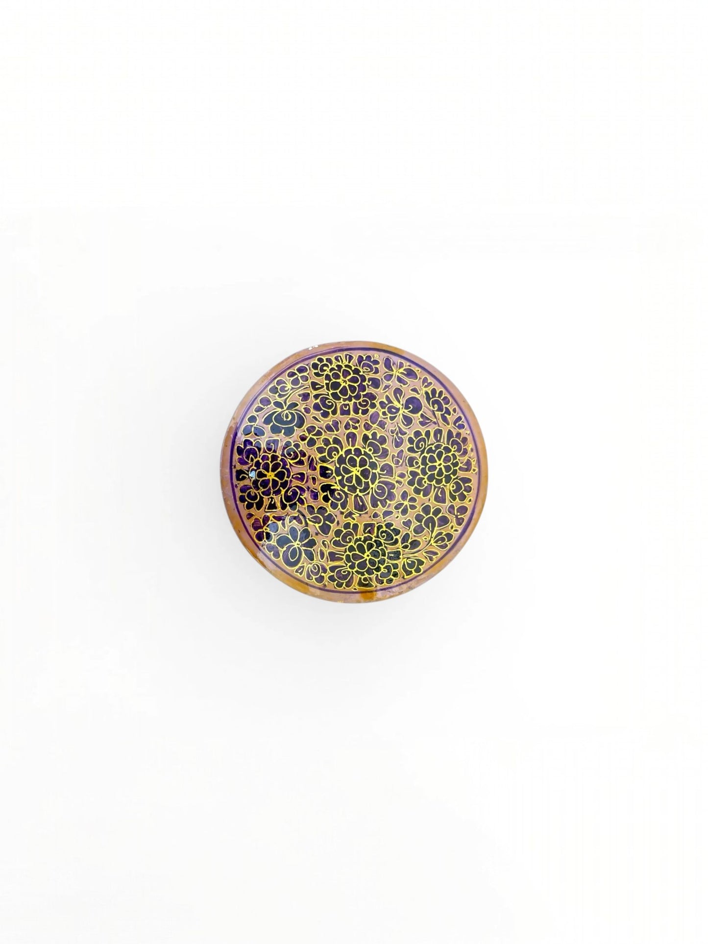 Noori Couture handpainted papier-mâché round coaster with intricate gold floral pattern on a purple background.