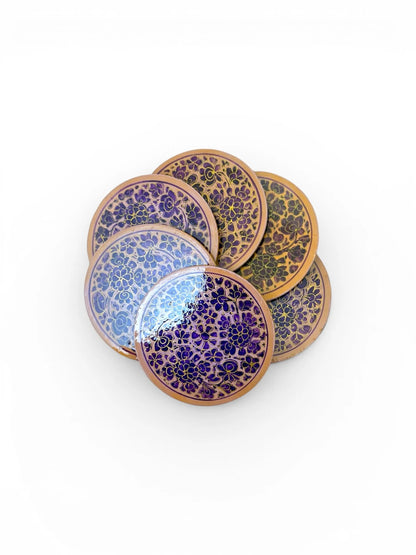 Noori Couture handpainted papier-mâché coasters with floral designs in purple and gold. Round set.