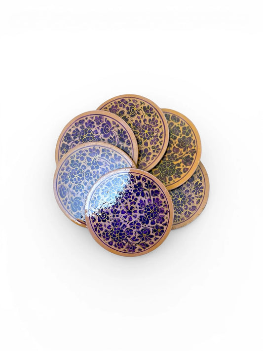 Noori Couture handpainted papier-mâché coasters with floral designs in purple and gold. Round set.