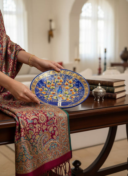Noori Couture handpainted papier-mâché decorative plate with Tree of Life motif in blue, orange, green, and gold.