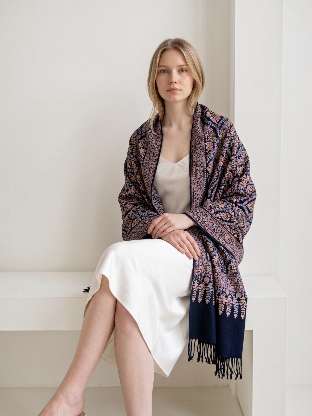 Model wearing a Noori Couture handwoven black Kalamkari shawl with intricate floral patterns and fringe detail.