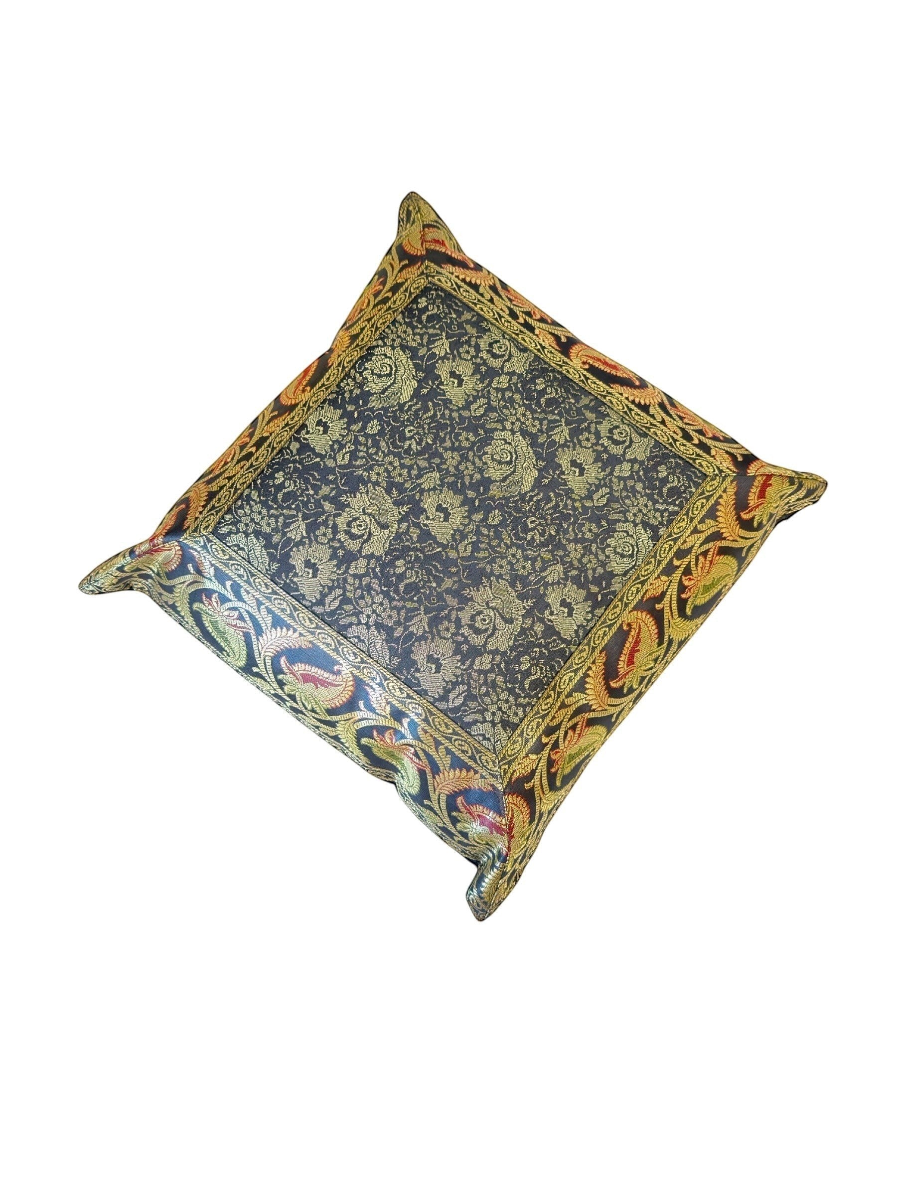 Noori Couture luxury handwoven pillow case with intricate floral pattern in gold on dark blue fabric, featuring a decorative border.