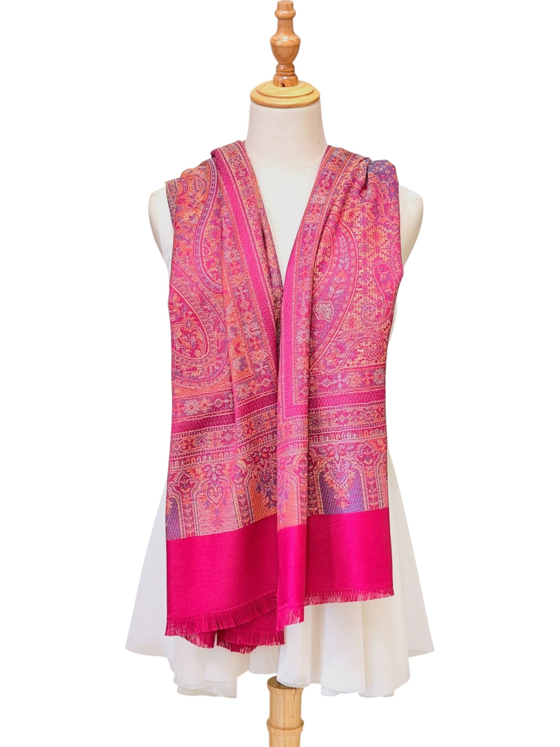 Noori Couture magenta pashmina shawl with intricate traditional paisley patterns and delicate fringe on a mannequin.