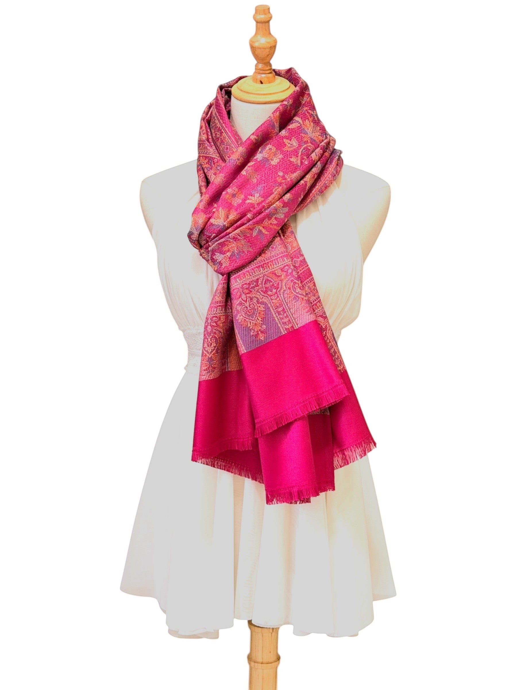 Noori Couture magenta pashmina shawl with intricate traditional paisley patterns and delicate fringe on a mannequin.