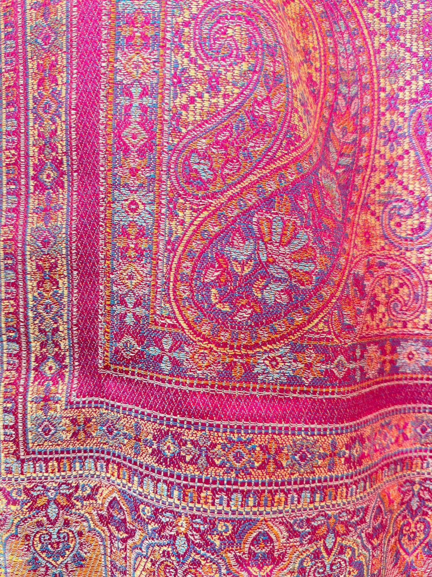 Noori Couture magenta pashmina shawl featuring an intricate multi-colored traditional paisley pattern and woven border