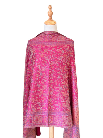 Noori Couture magenta pink shawl wrap with intricate traditional woven patterns and delicate fringe on a mannequin