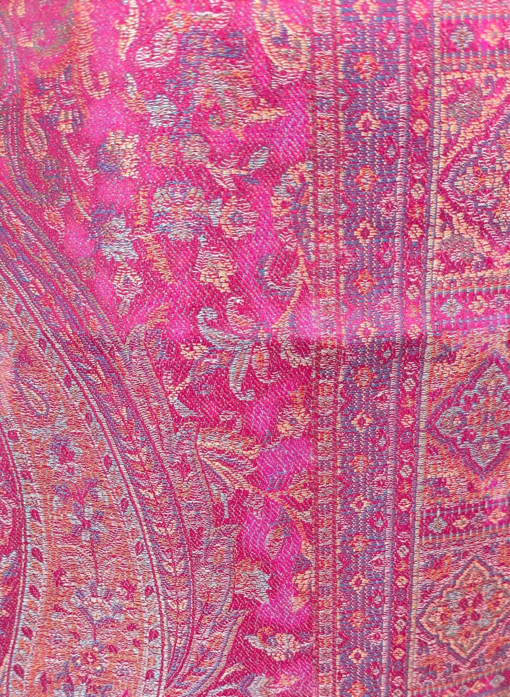 Noori Couture magenta pink shawl wrap featuring intricate traditional woven patterns and soft cotton-wool blend texture.