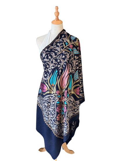 Noori Couture handwoven Montana Blue wool shawl featuring intricate multi-colored silk floral and vine embroidery.