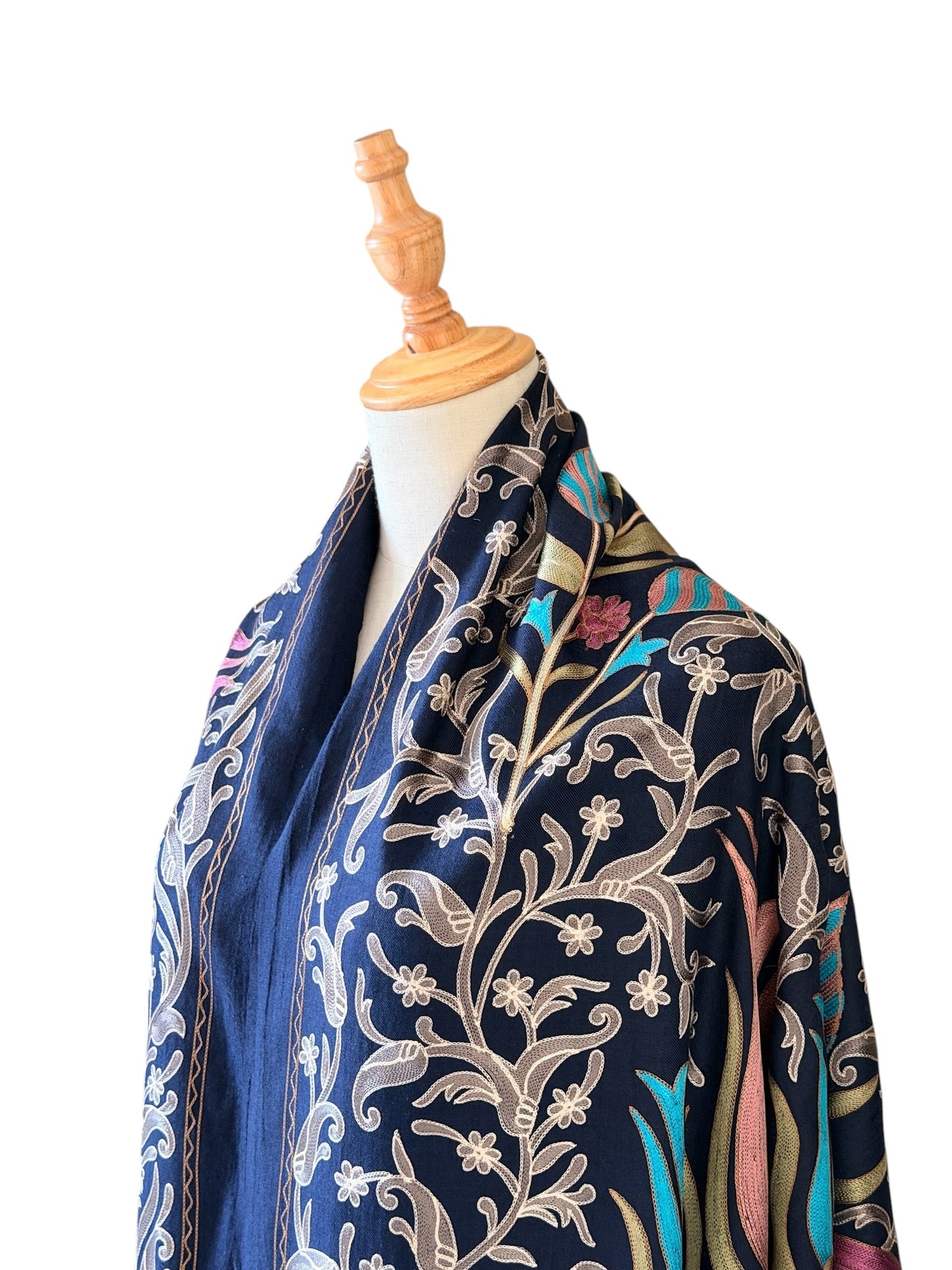 Noori Couture handwoven Montana Blue wool shawl with intricate multi-colored silk floral embroidery on a mannequin.