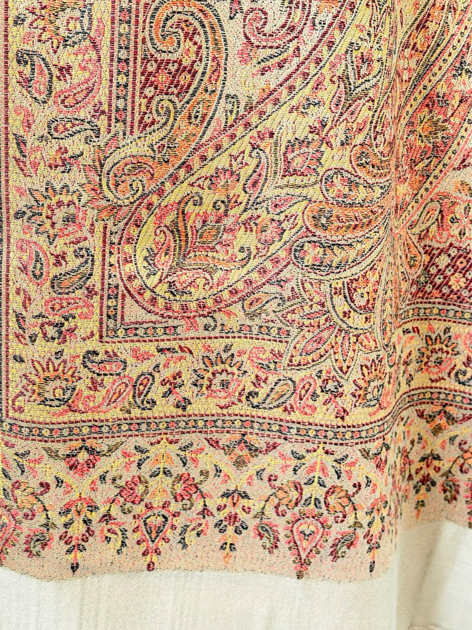 Noori Couture desert brown pashmina shawl featuring an intricate multi-colored paisley pattern and delicate fringe.