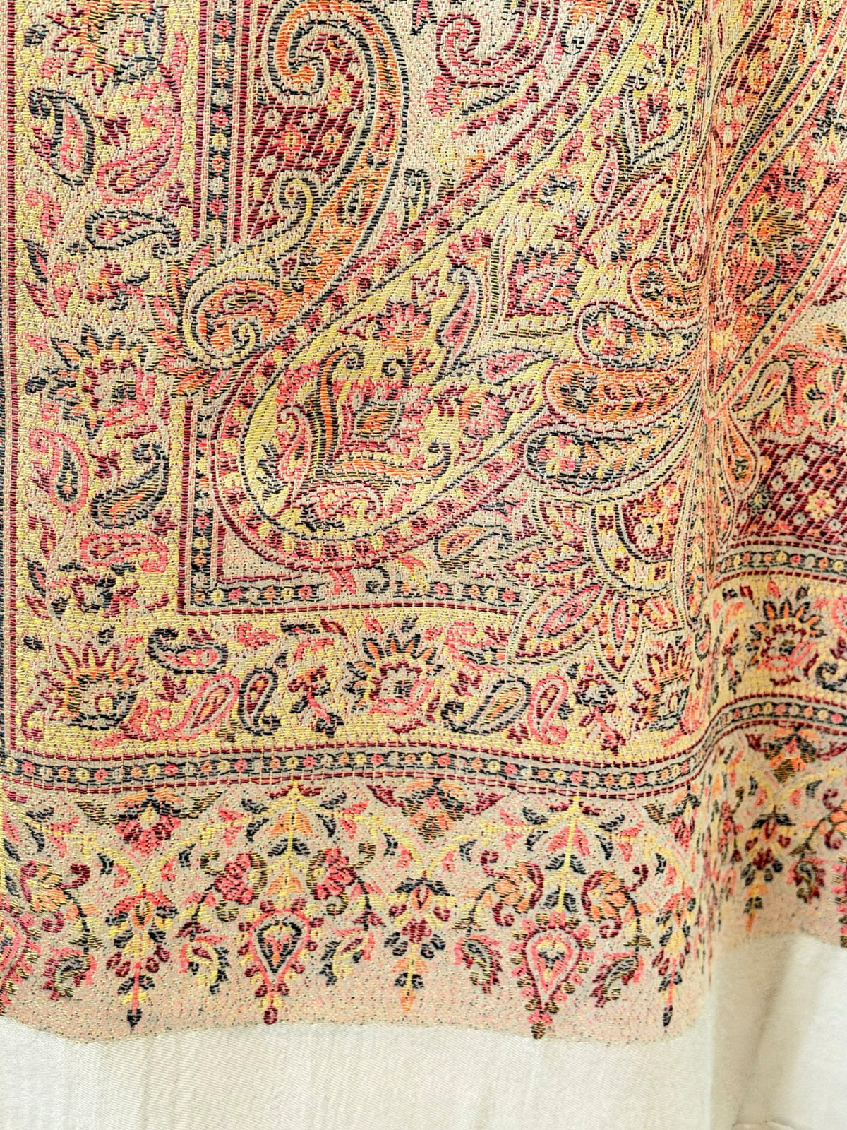 Noori Couture desert brown pashmina shawl featuring an intricate multi-colored paisley pattern and delicate fringe.