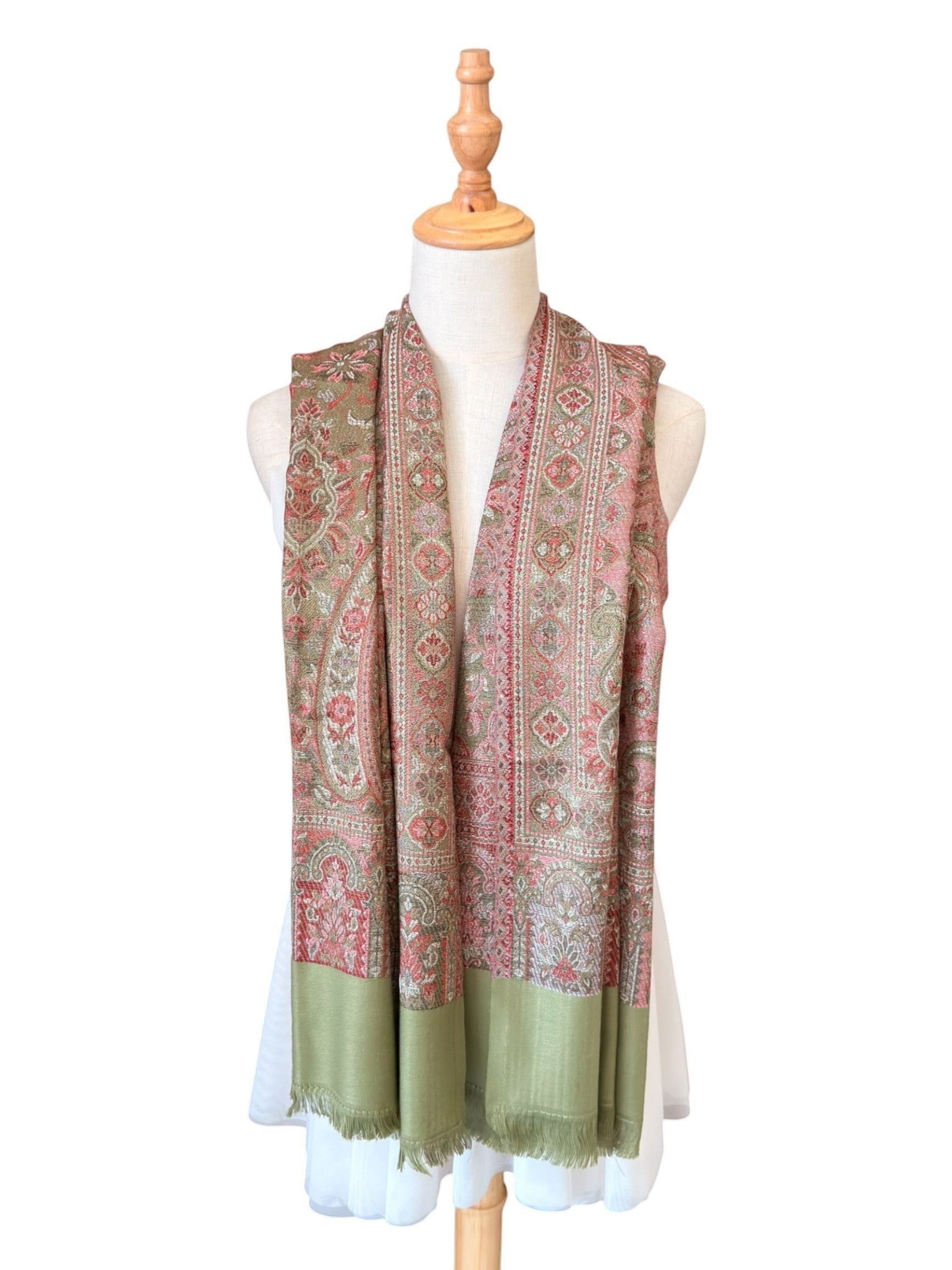 Noori Couture pashmina shawl in sage green and rose paisley print with fringe trim, crafted from cotton and wool.