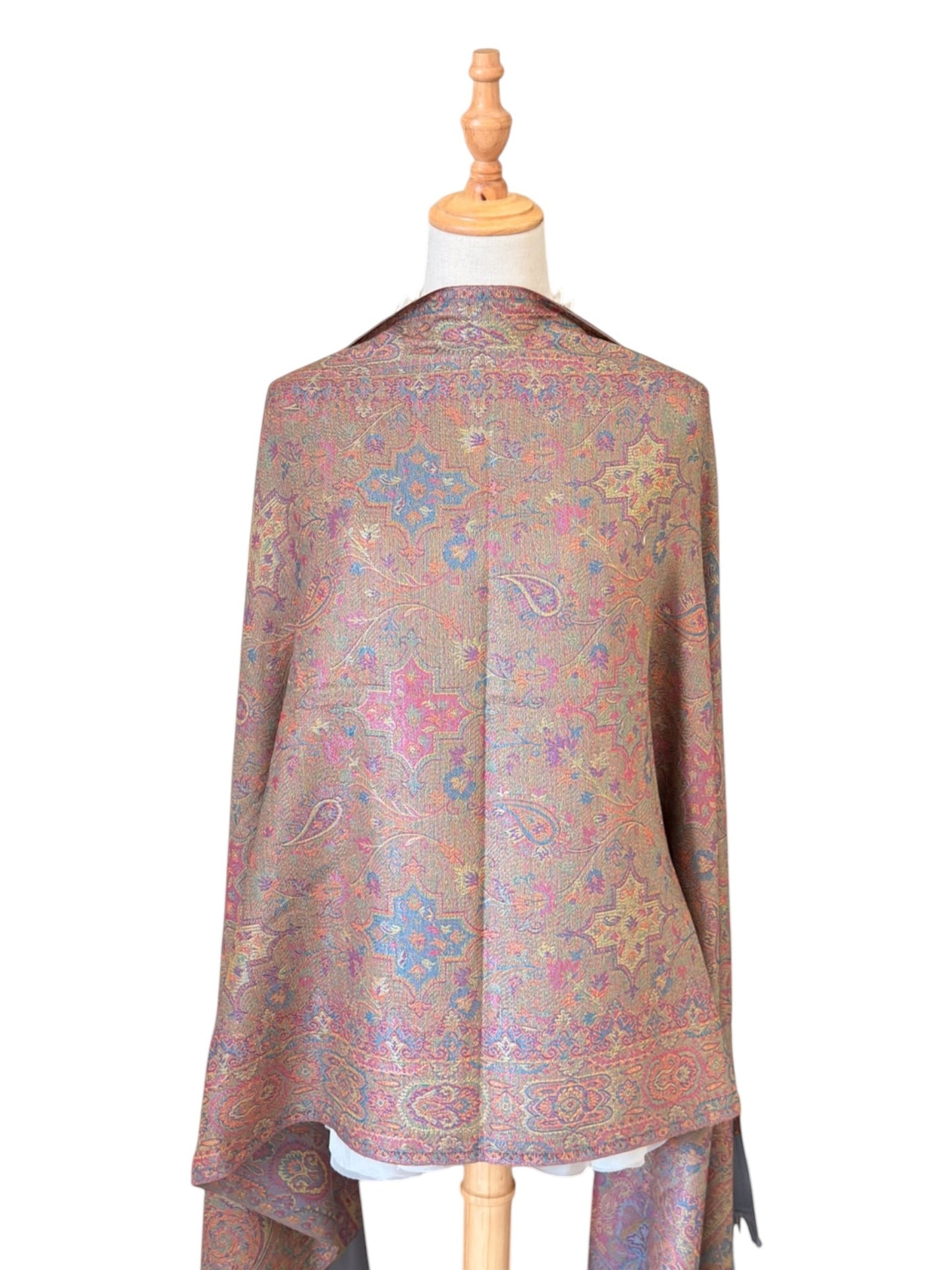 Noori Couture pashmina shawl in sea weed grey with intricate paisley patterns in coral, gold, and violet on a mannequin.